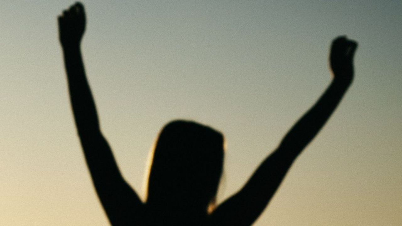 Woman with arms raised 