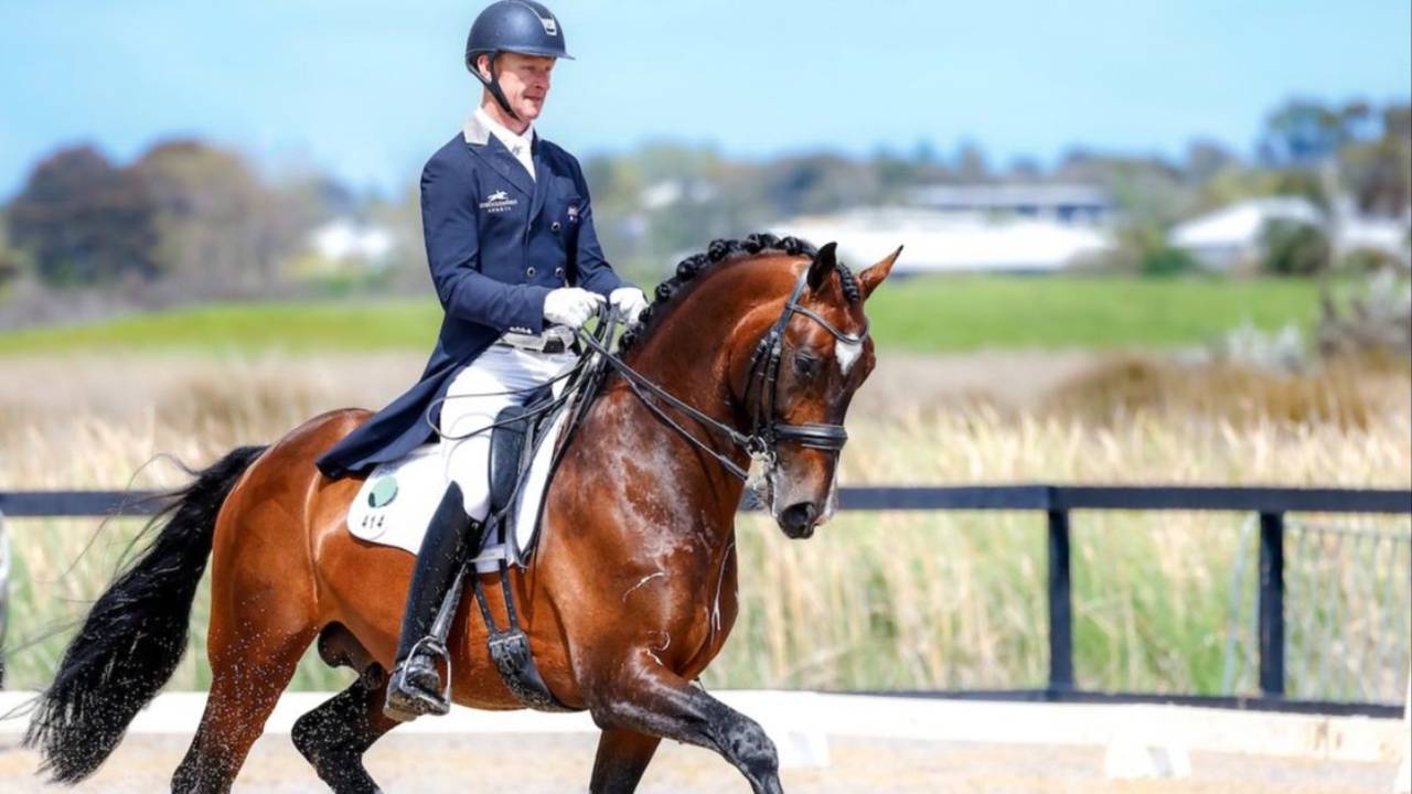 Dressage rider Brett Parbery rides a trot in adressage test on his horse