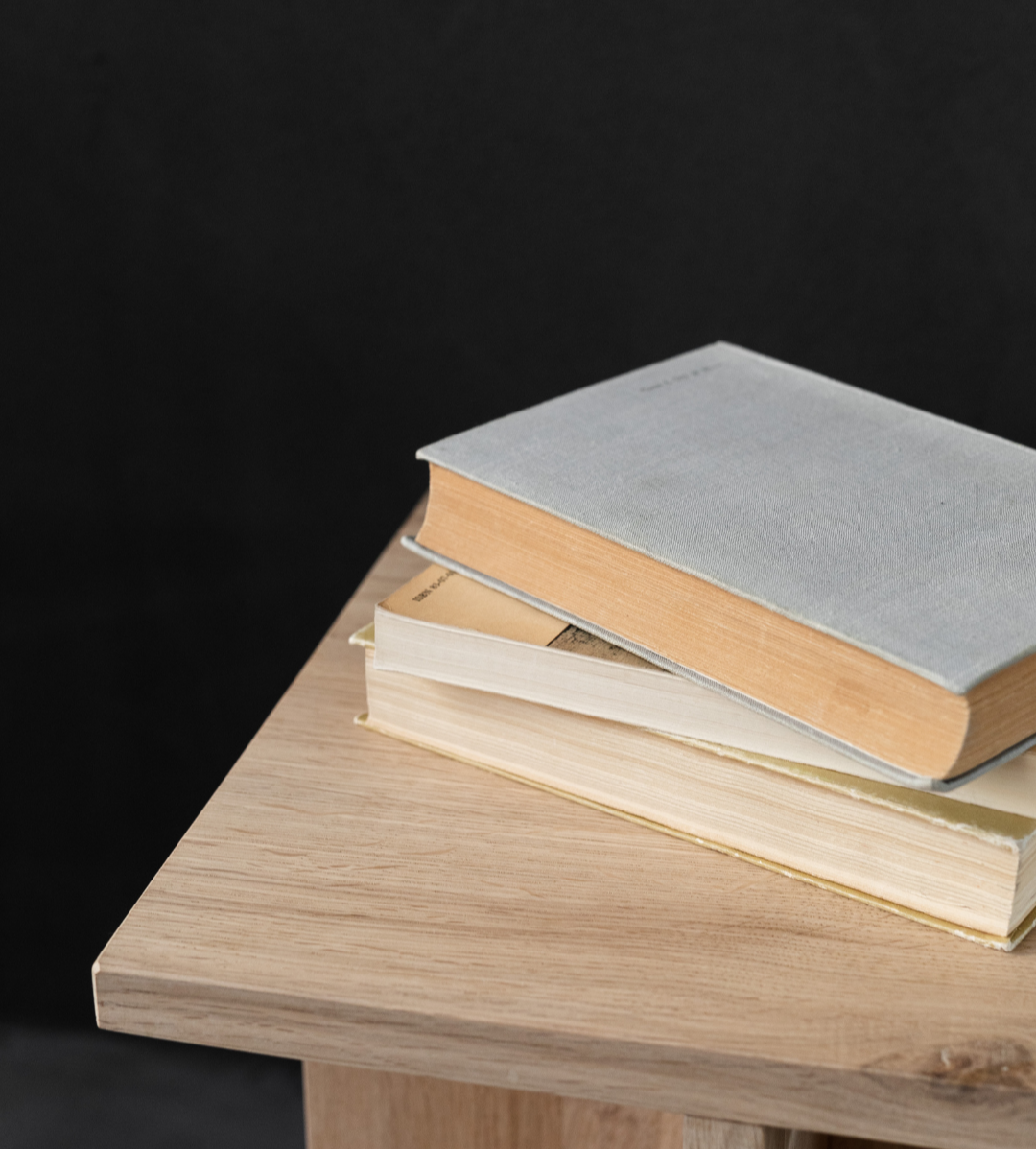 Close up fo books on wooden side table for business growth entrepreneurs.