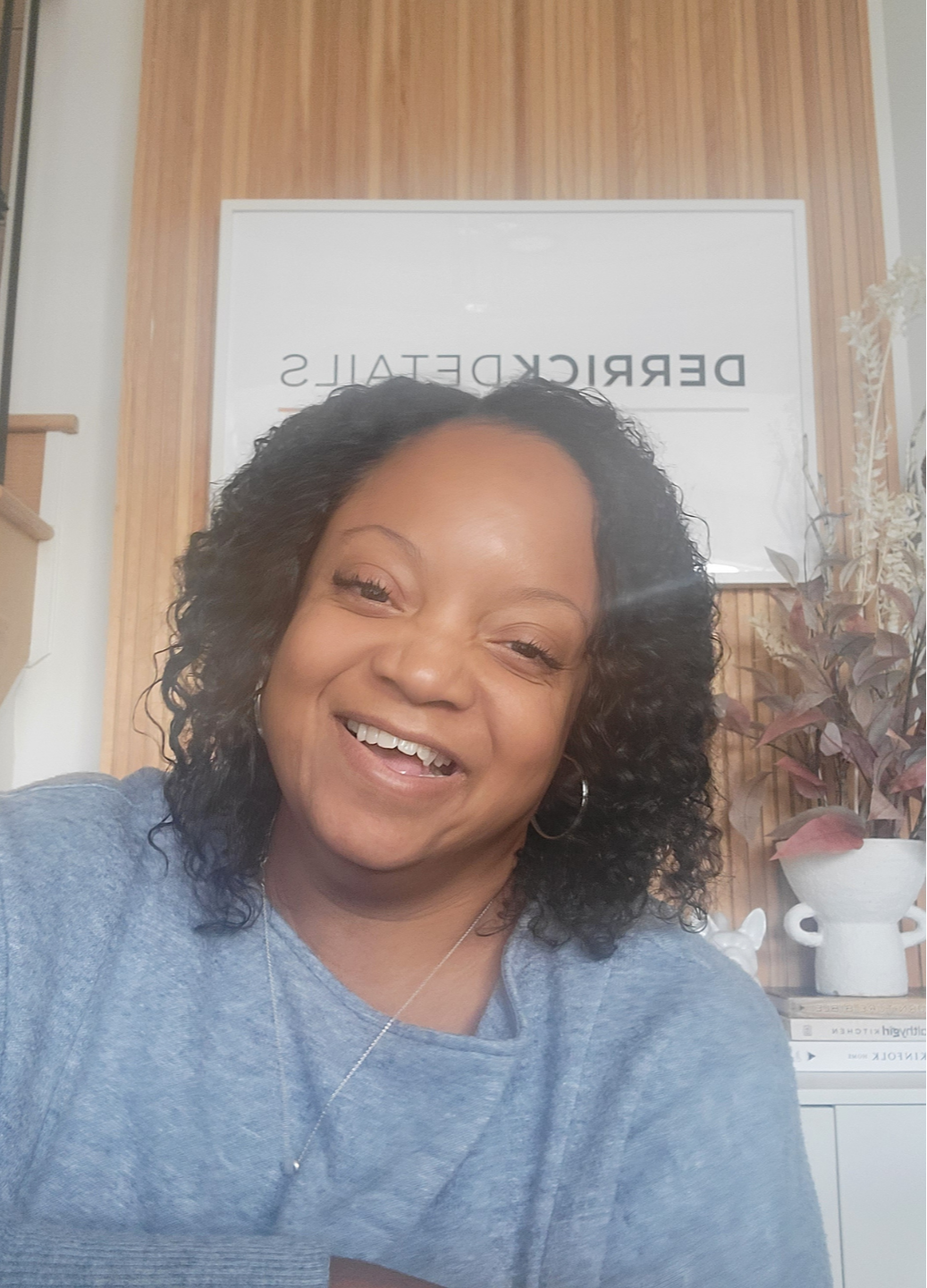Chiriga Derrick smiling warmly, sharing her personality and fun facts on the About page.