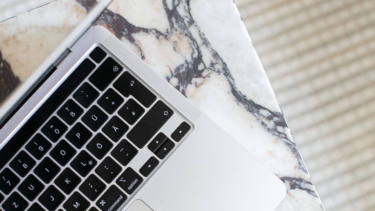laptop on marble table with What's Your Entrepreneurial Edge? quiz 