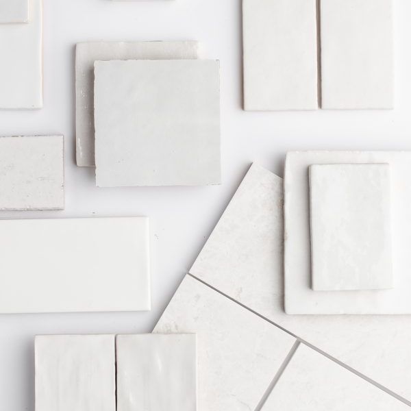 Close-up of a designer selecting fabric swatches, representing the personalized and detailed approach to interior design services.