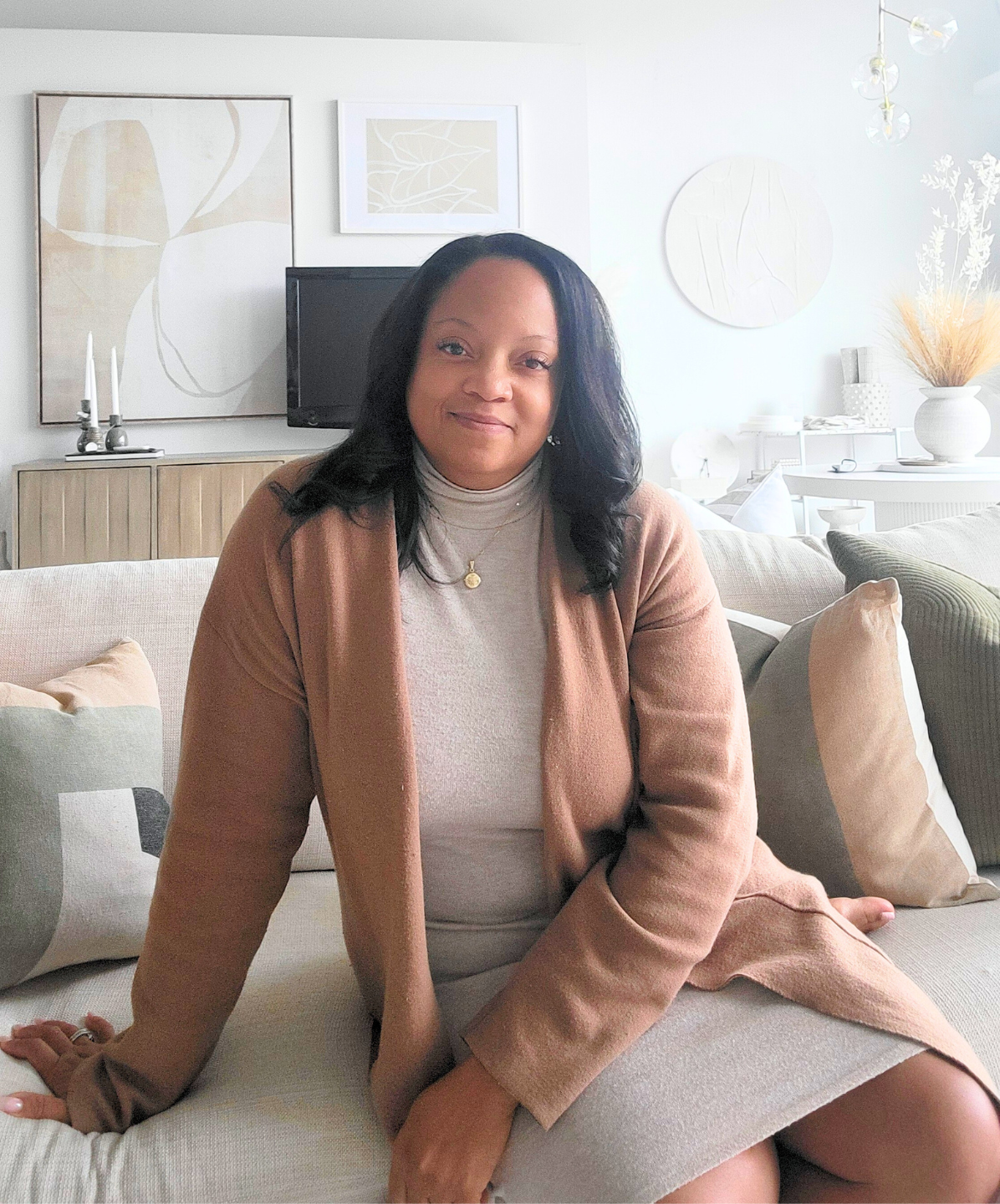 Chiriga Derrick sitting in a beautifully styled room at Derrick Details Boutique, promoting her mission of empowering entrepreneurs to thrive in business and life.