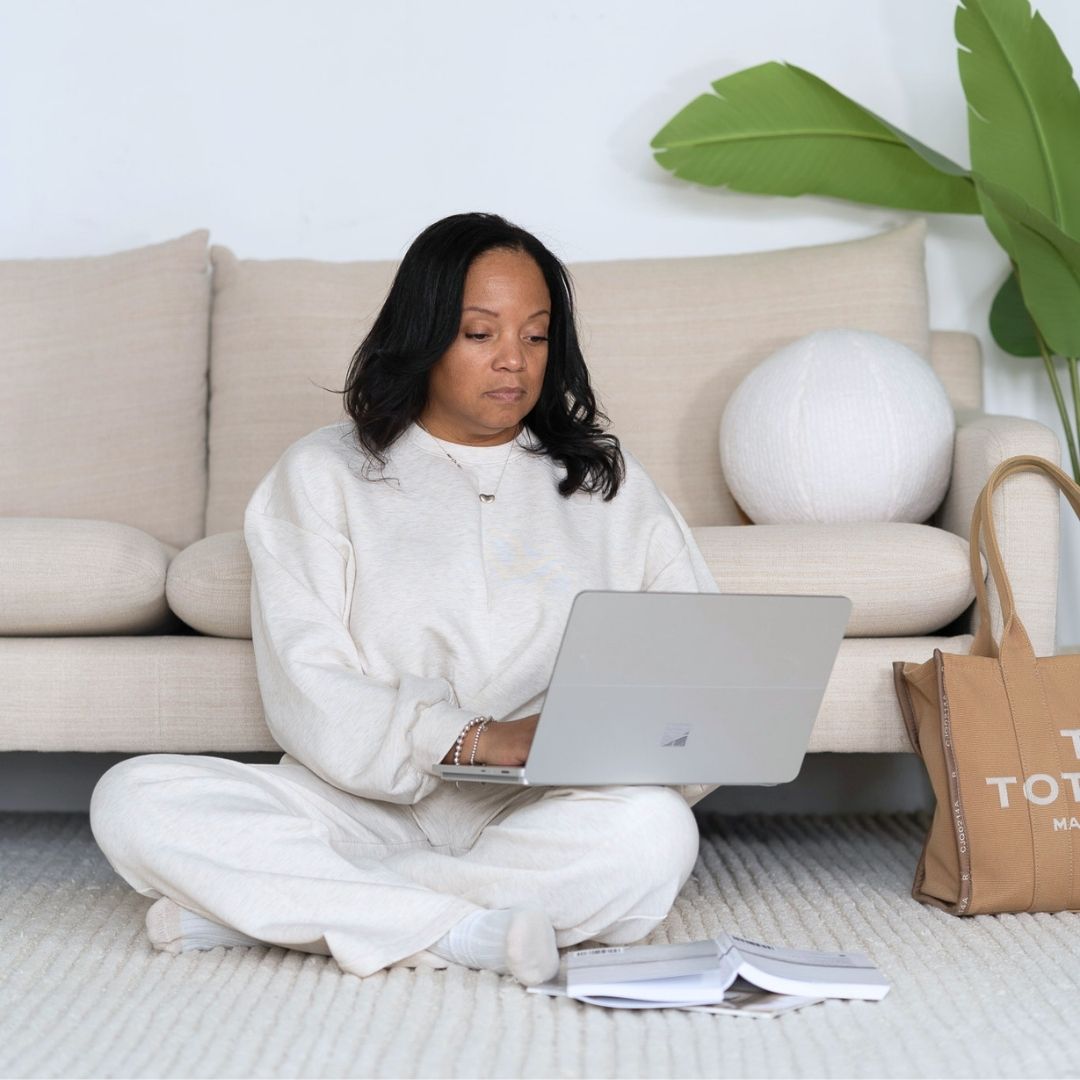 Chiriga Derrick standing confidently in her office, representing her mission to empower entrepreneurs to thrive in business and life.