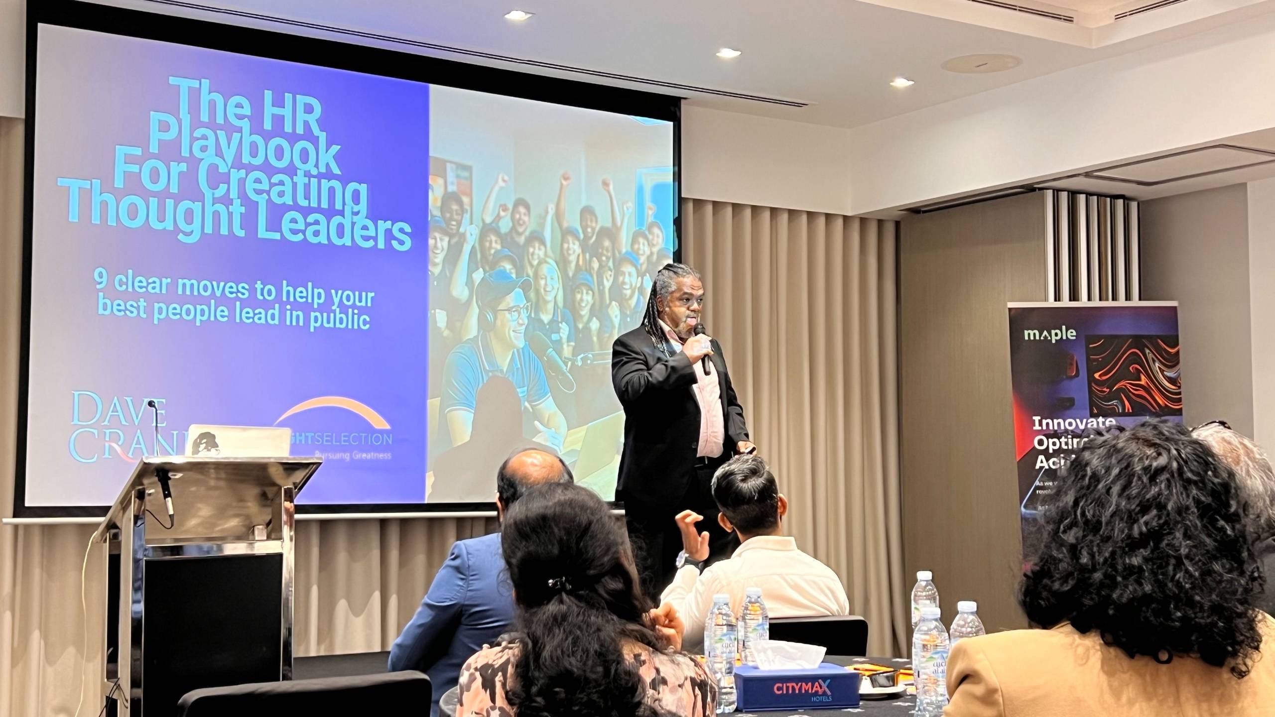 Dave Crane delivering a leadership keynote on creating thought leaders to a corporate audience in Dubai.
