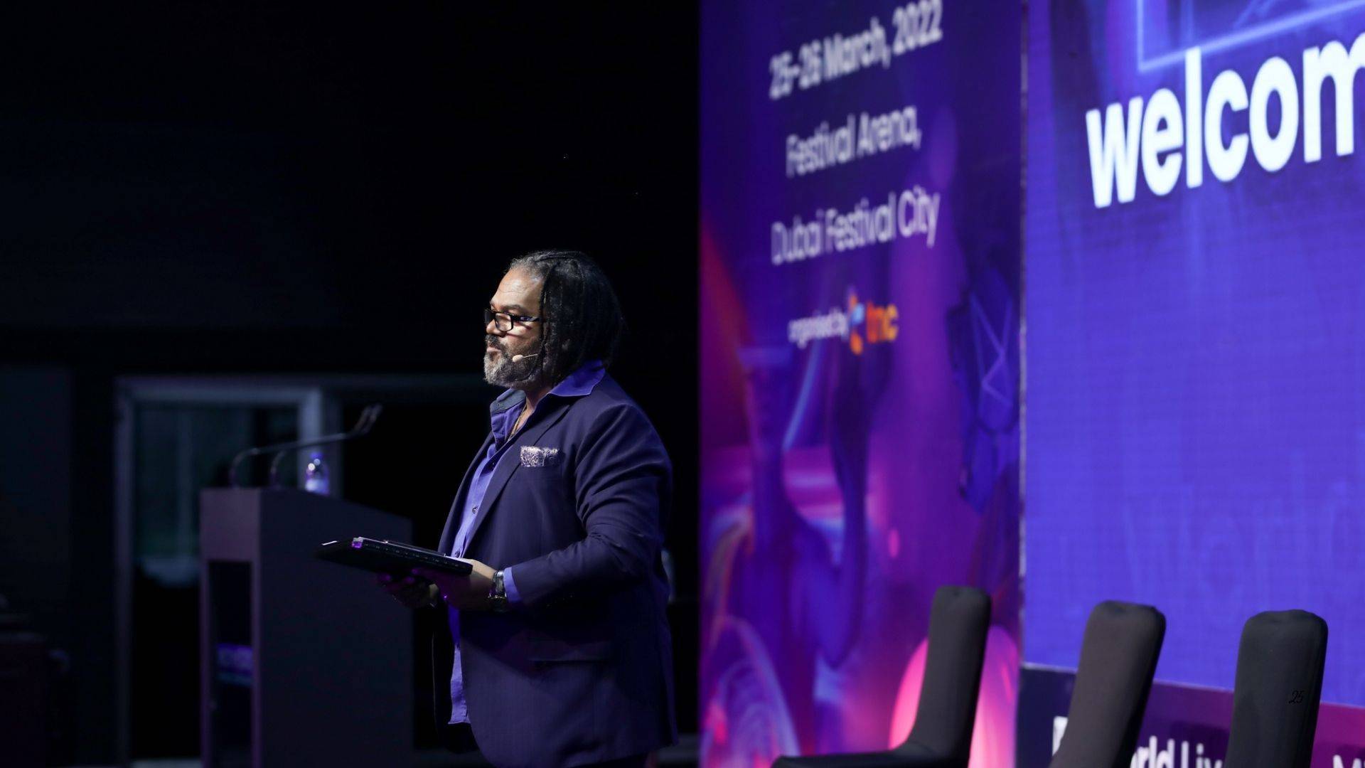 Dave Crane presenting on the main stage at Dubai Festival Arena during a large international event.