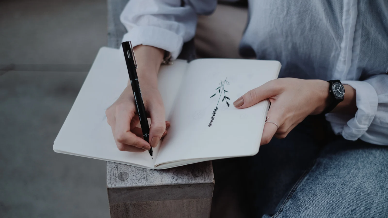 closeup of woman writing in a journal