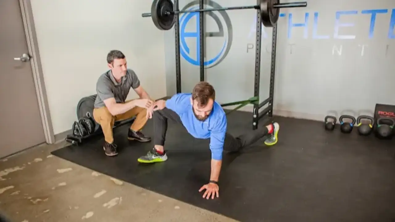 Patient working with a provider at a performance physical therapy clinic in Decatur, GA during a lower extremity strengthening session