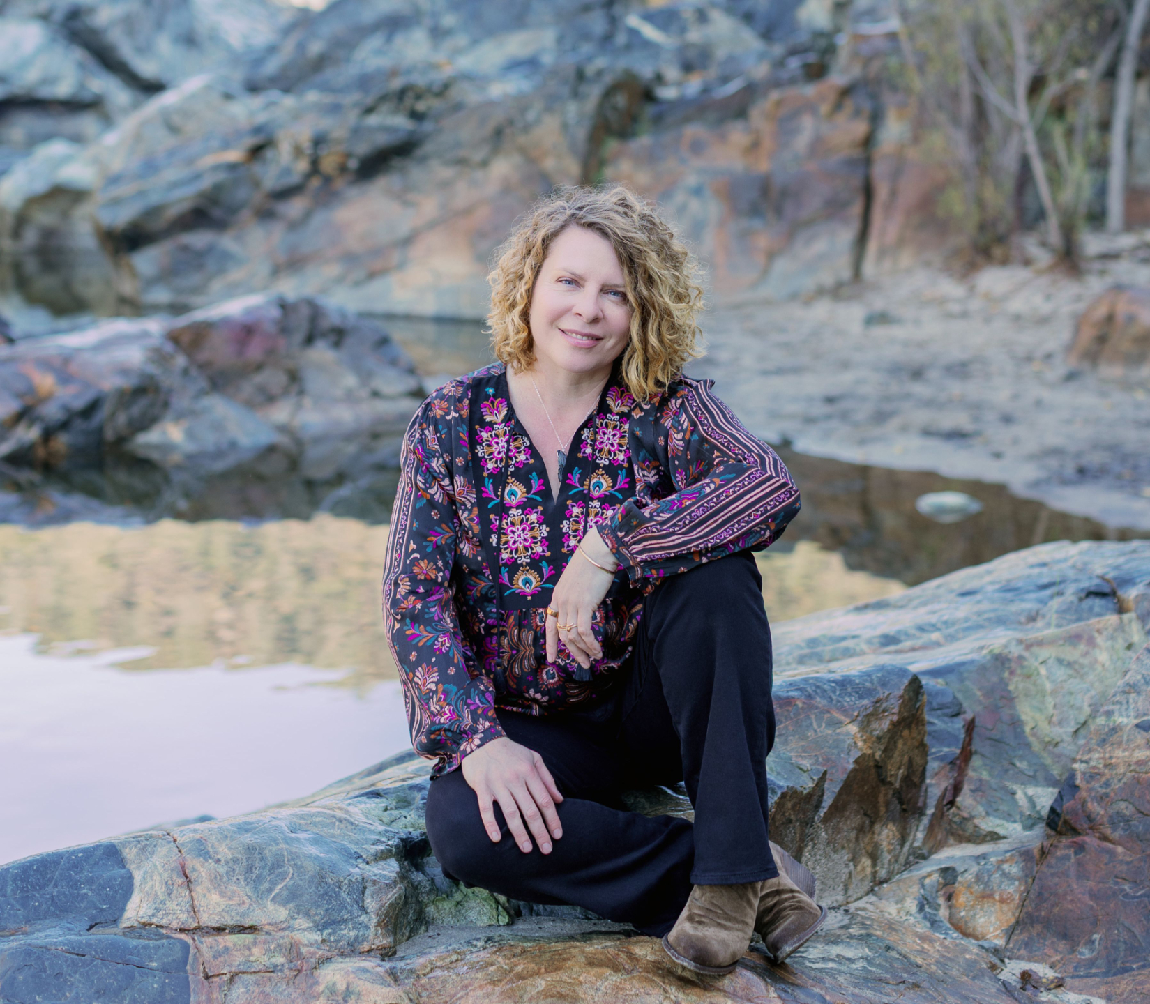 Radha Heartwell sitting by the water
