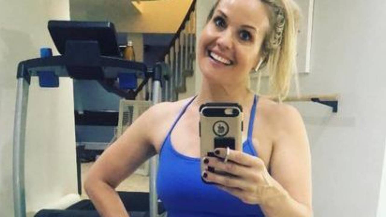 Woman over 40 doing a simple five-minute workout at home, showing how small steps can build strength, confidence, and consistency in midlife.