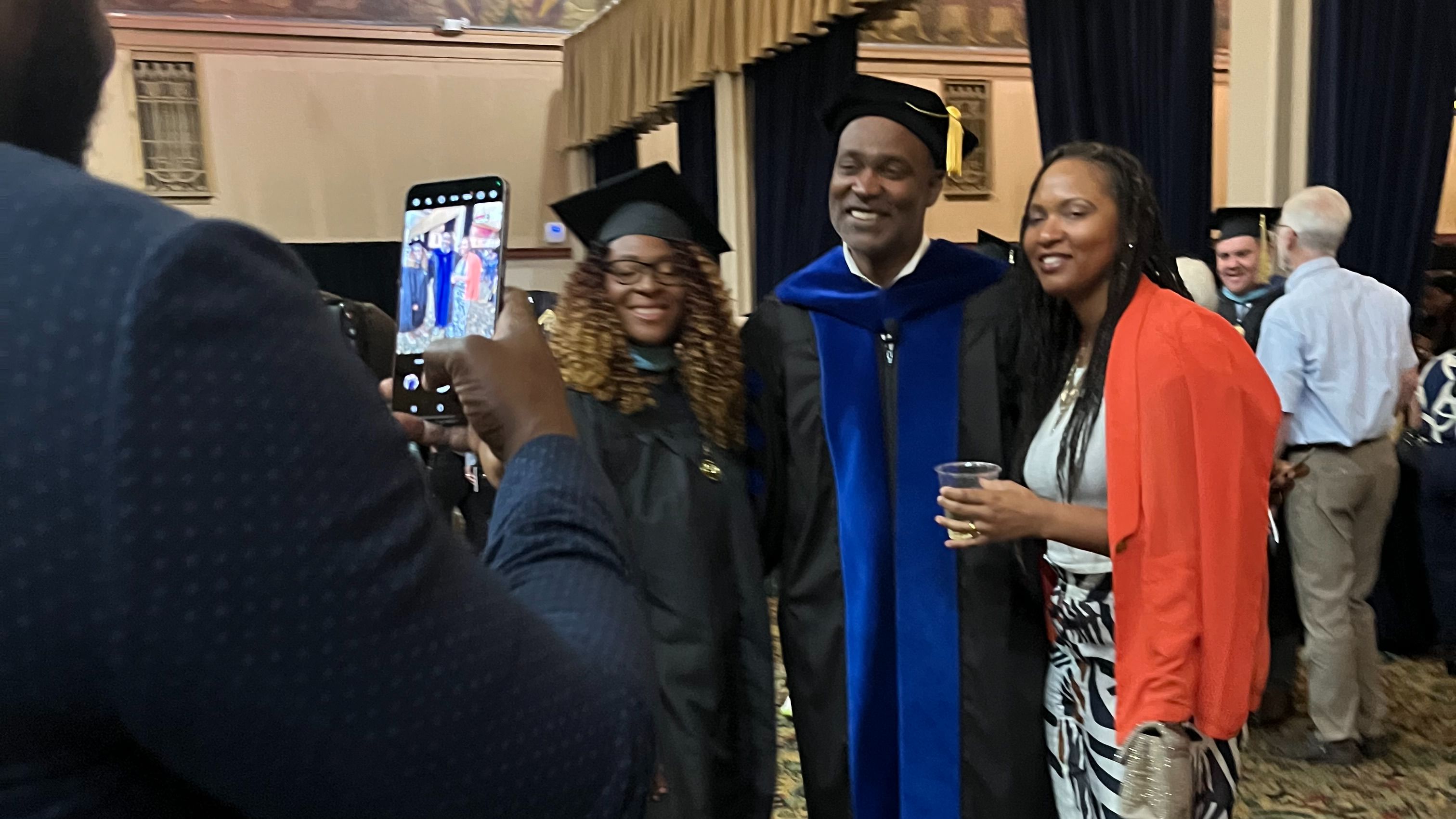 Ivan greeting students after a Commencement speech