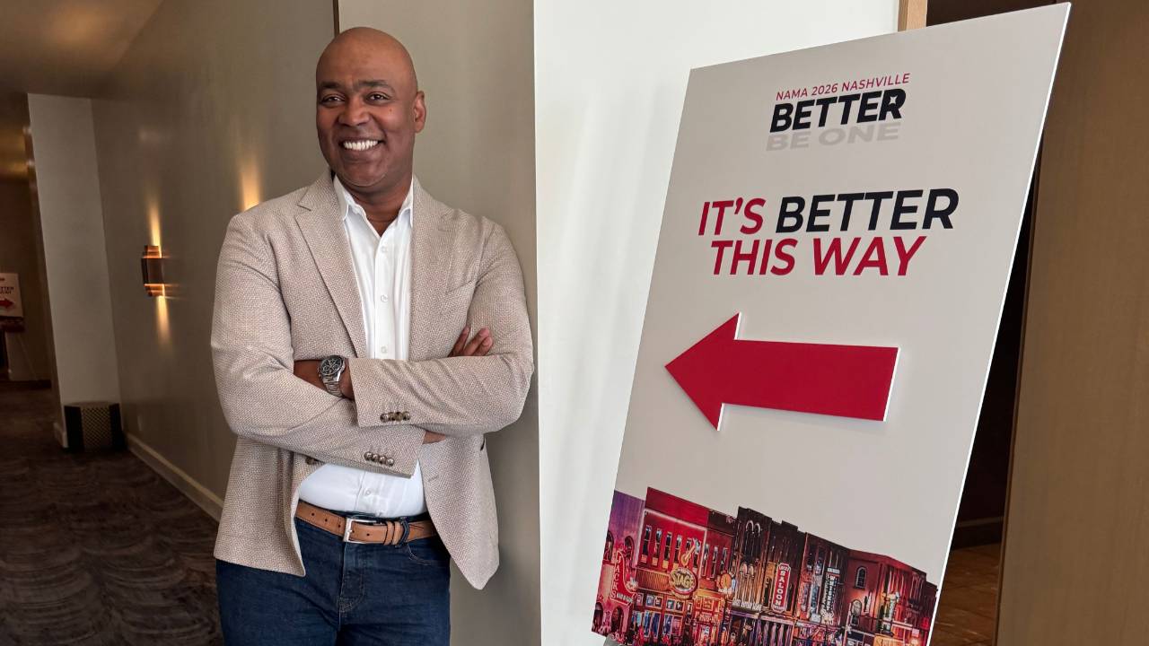 Ivan standing by a sign saying, "It's Better This Way."