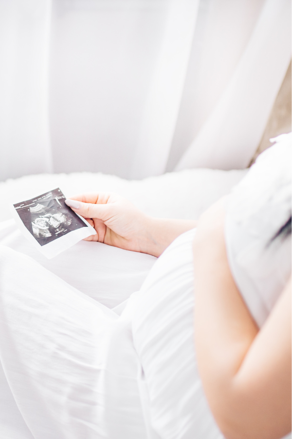 Mother holding pregnancy scan