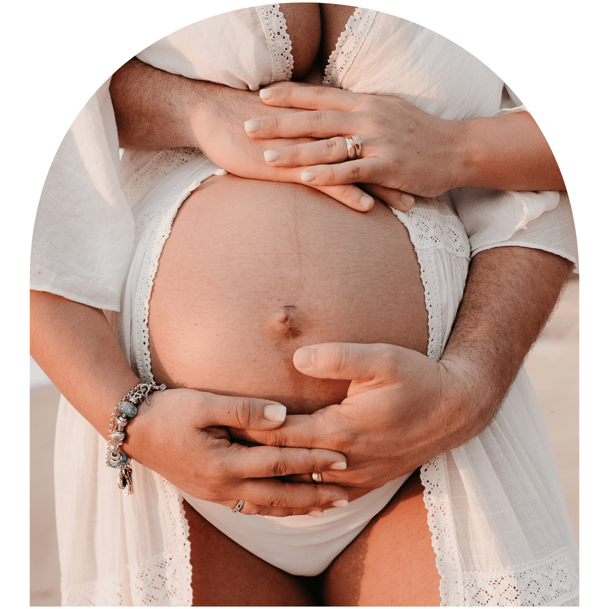 Pregnant belly - husband embracing from behind 
