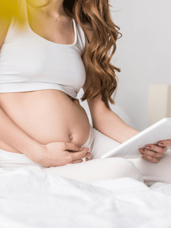 Partial view of long-haired pregnant woman