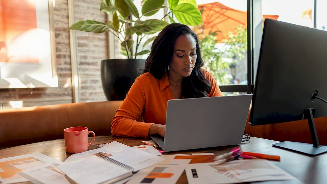 woman setting up her affiliate program using a laptop