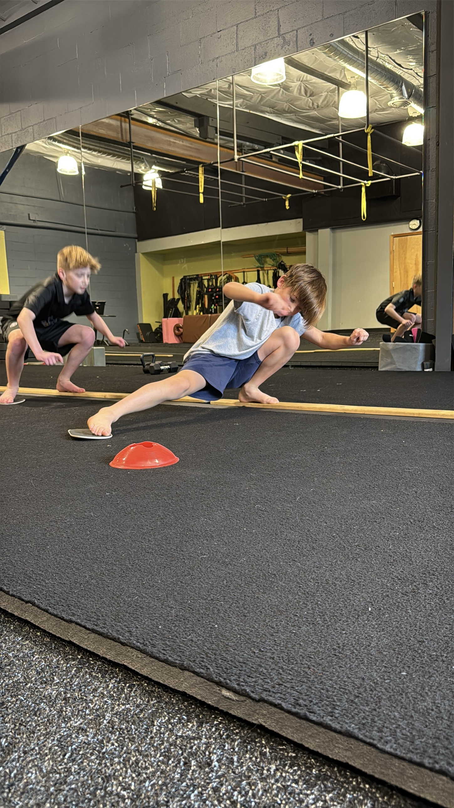 Young athletes training lateral lunges at Movement Gym