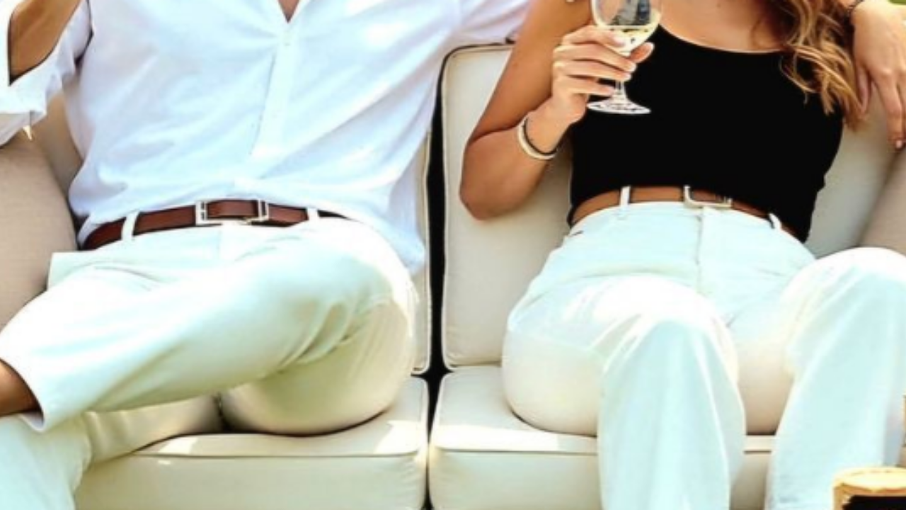 Clean still from a Happy Soul Films wedding film: couple seated together during a cinematic reception moment.