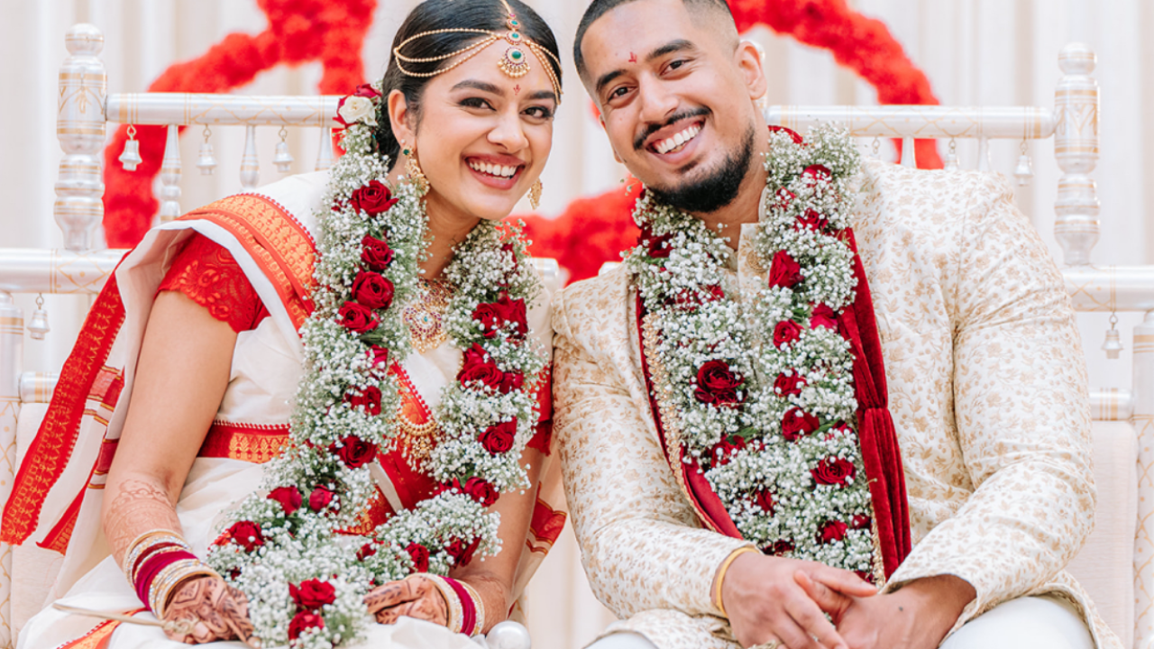 Clean still from a Happy Soul Films South Asian wedding film: joyful couple in traditional attire.