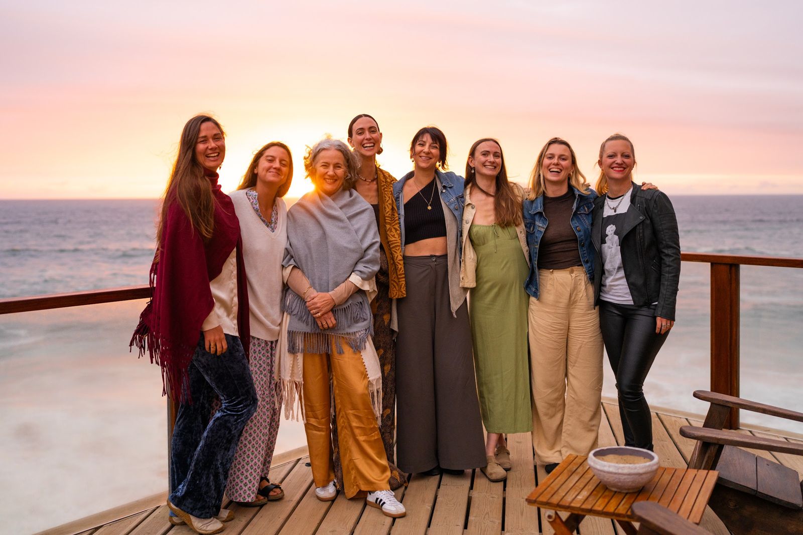 The women of the retreat together on the deck at sunset
