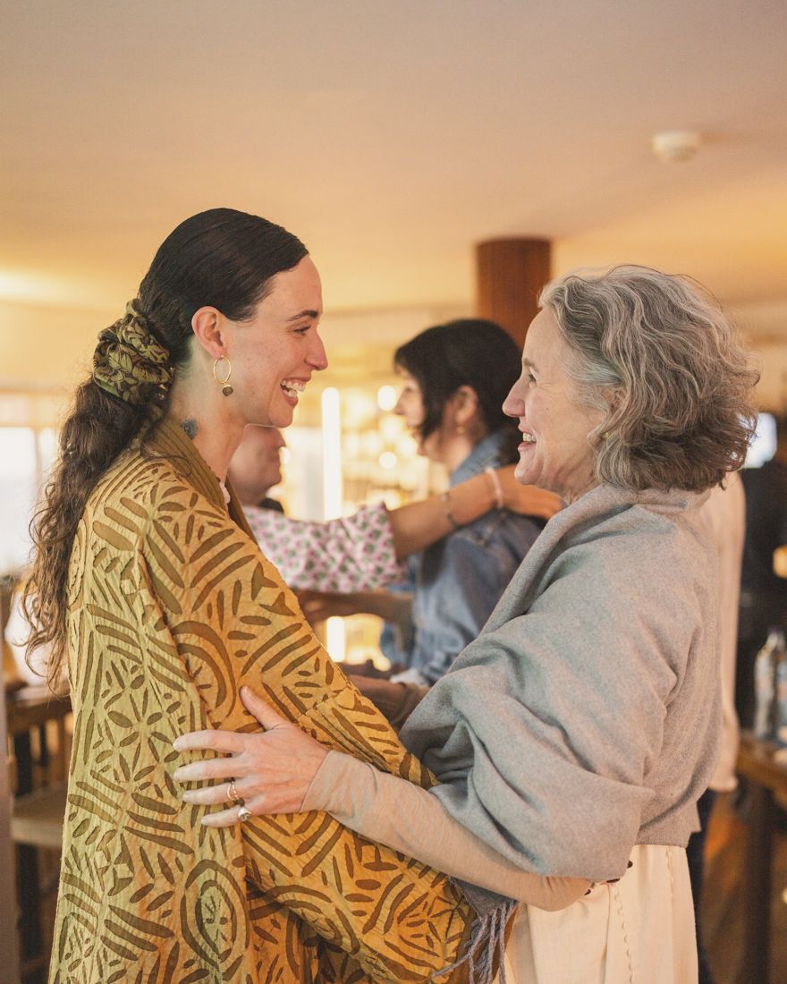 Georgiana embracing one of the women at the retreat