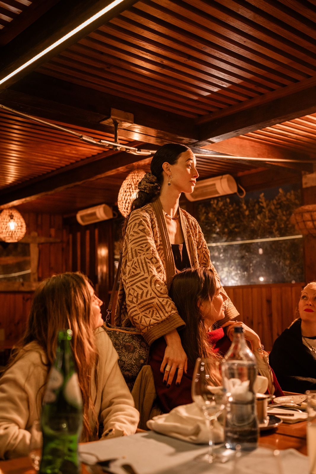 Georgiana at the retreat dinner table, surrounded by the women