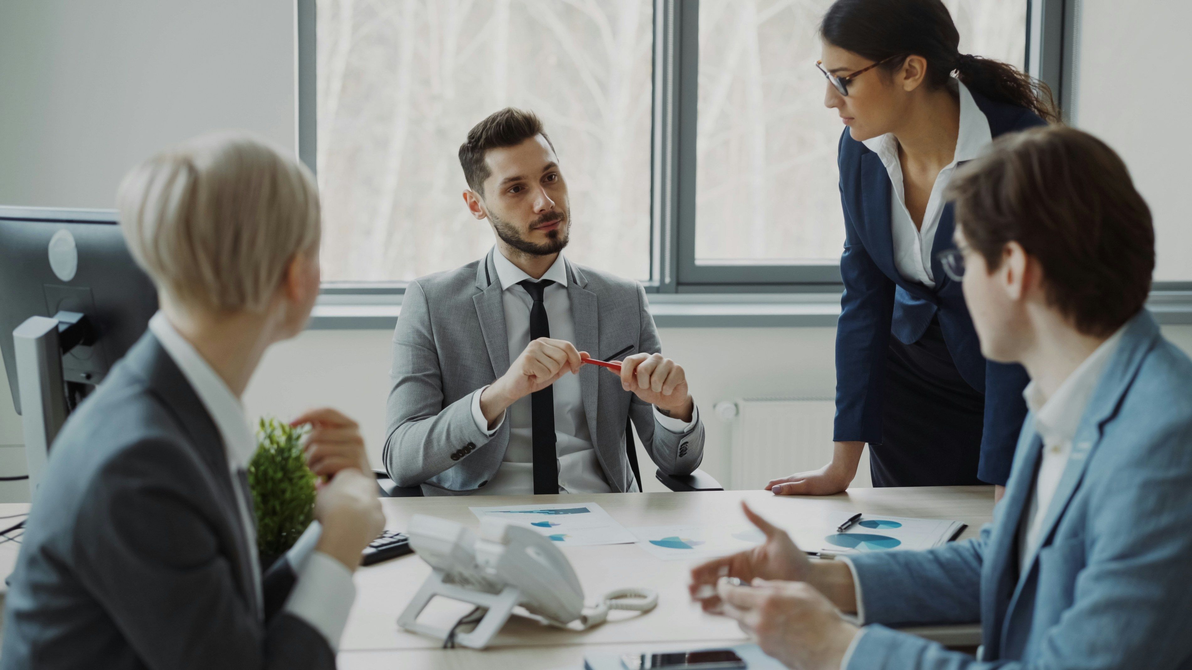 Leader listening attentively as team members share ideas during a meeting.