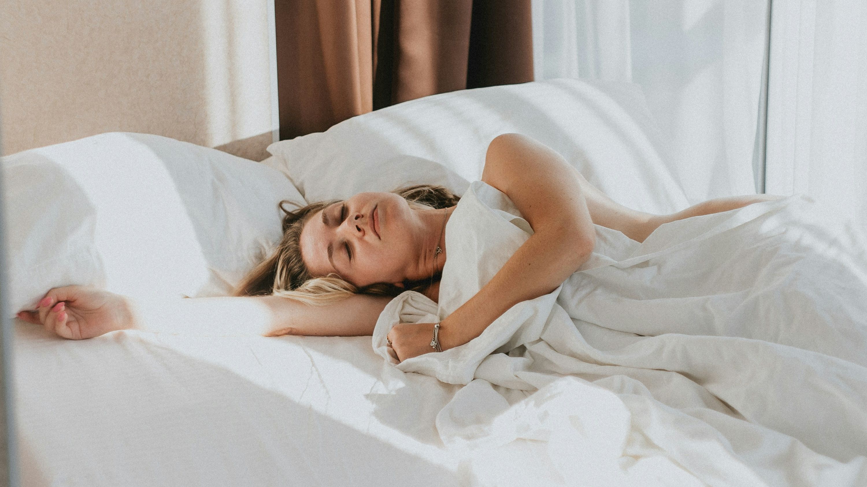 Person sleeping peacefully highlighting sleep is essential for health and performance.