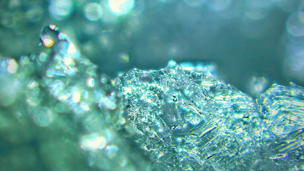 A blue-greenish gel-like substance, zoomed into the camera, meant to represent the concept of EZ Water.
