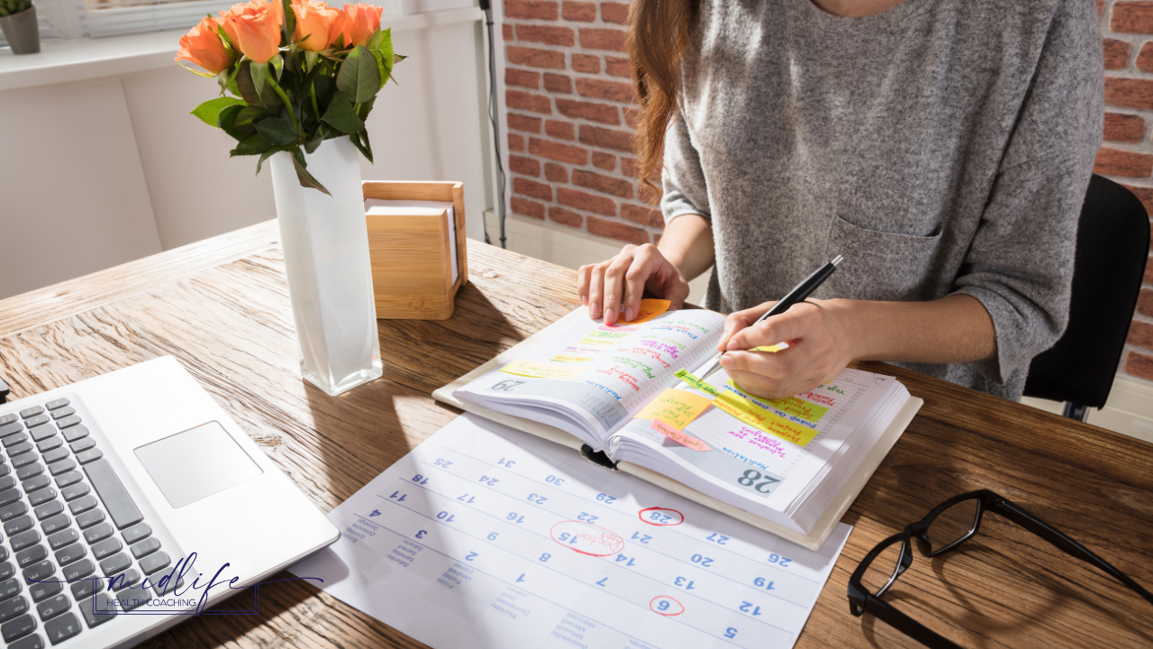 Woman looking at an open calendar during empty nest transition"