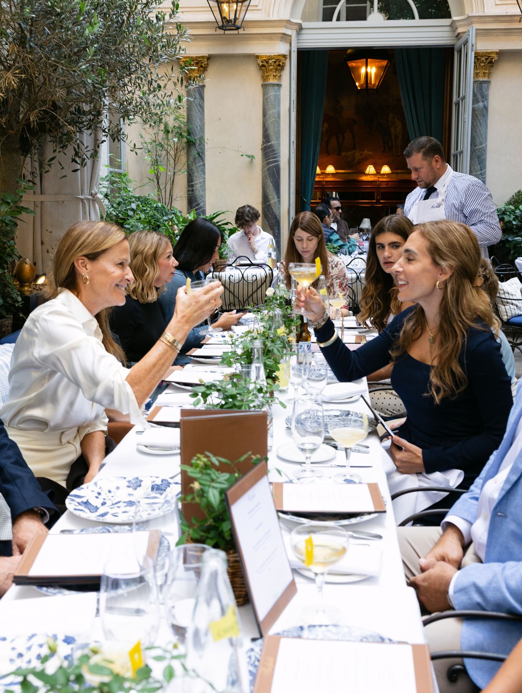 EDGE members raising a toast at a long table in Paris