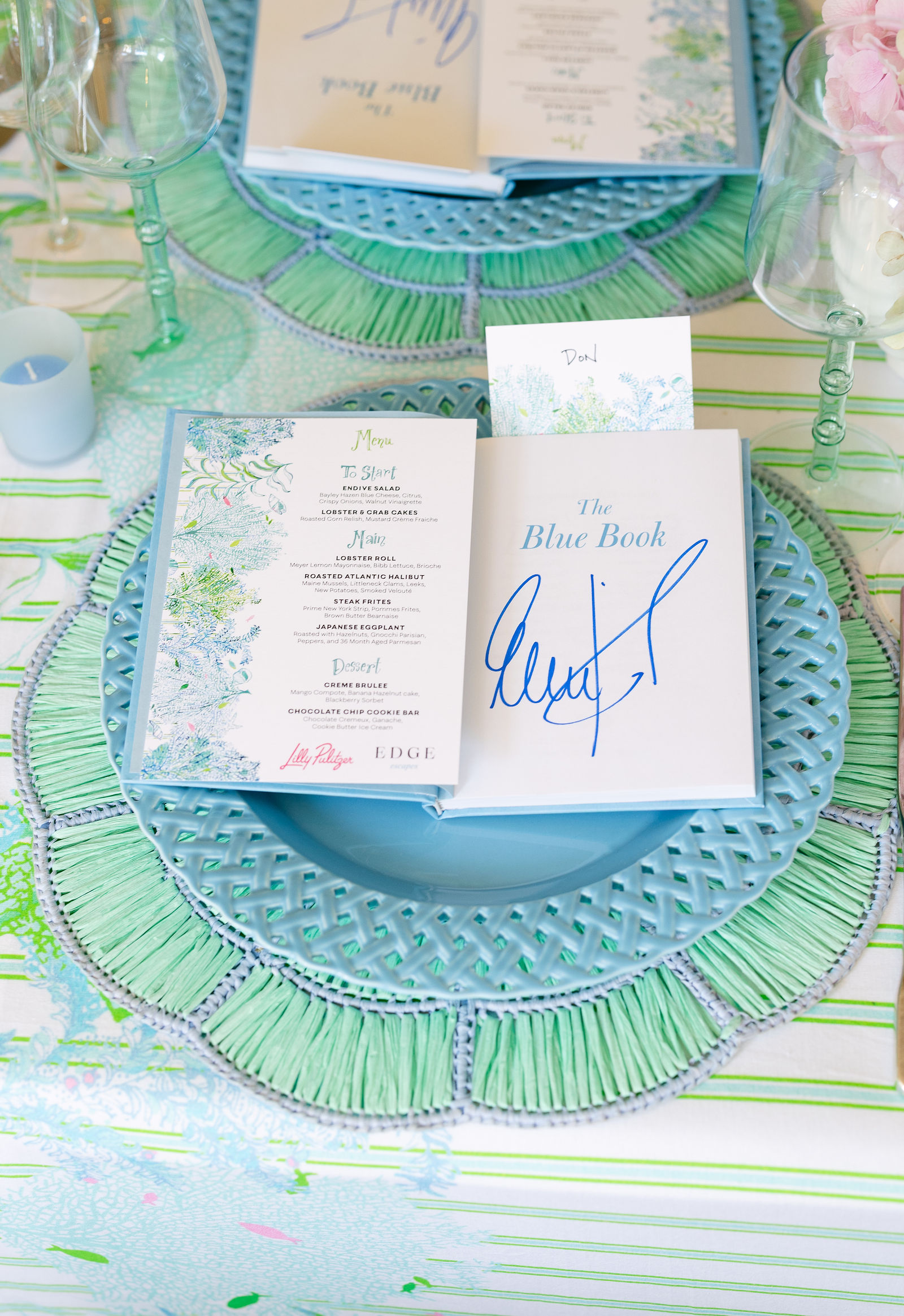 A signed copy of The Blue Book at each place