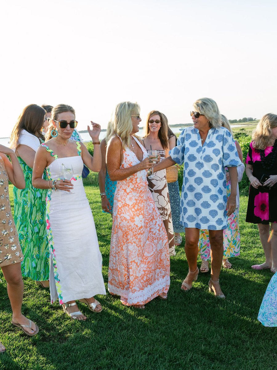 EDGE members mingling on the lawn at sunset on Nantucket