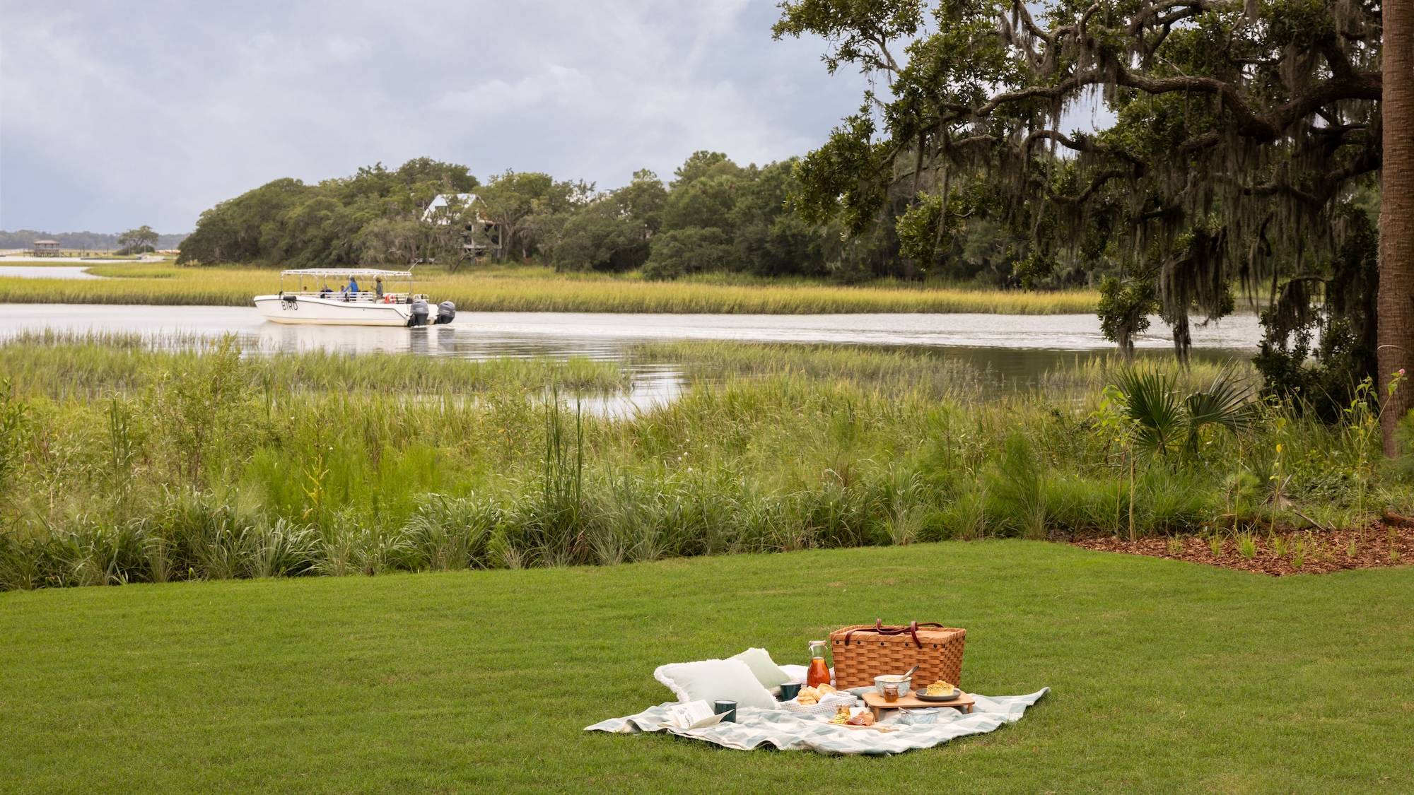 A picnic on the lawn beside the marsh at The Dunlin