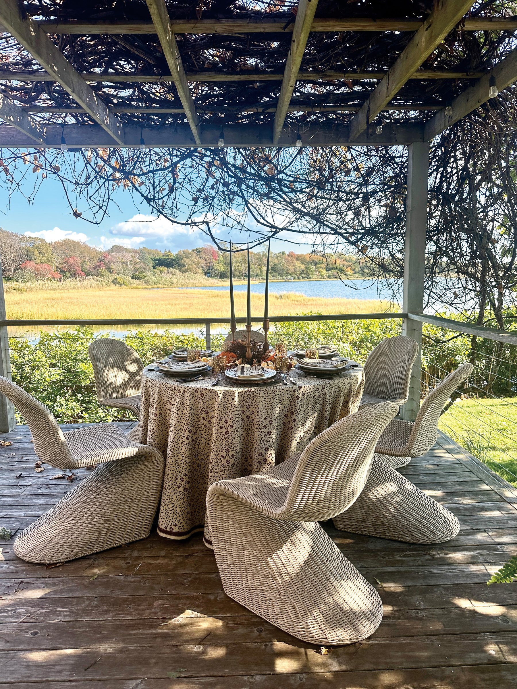 An autumn table under a pergola overlooking the marsh