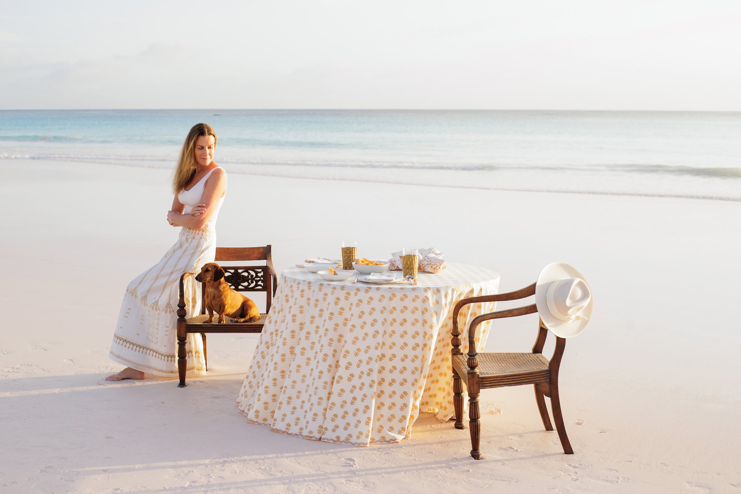 India Hicks at a table on the beach in the Bahamas