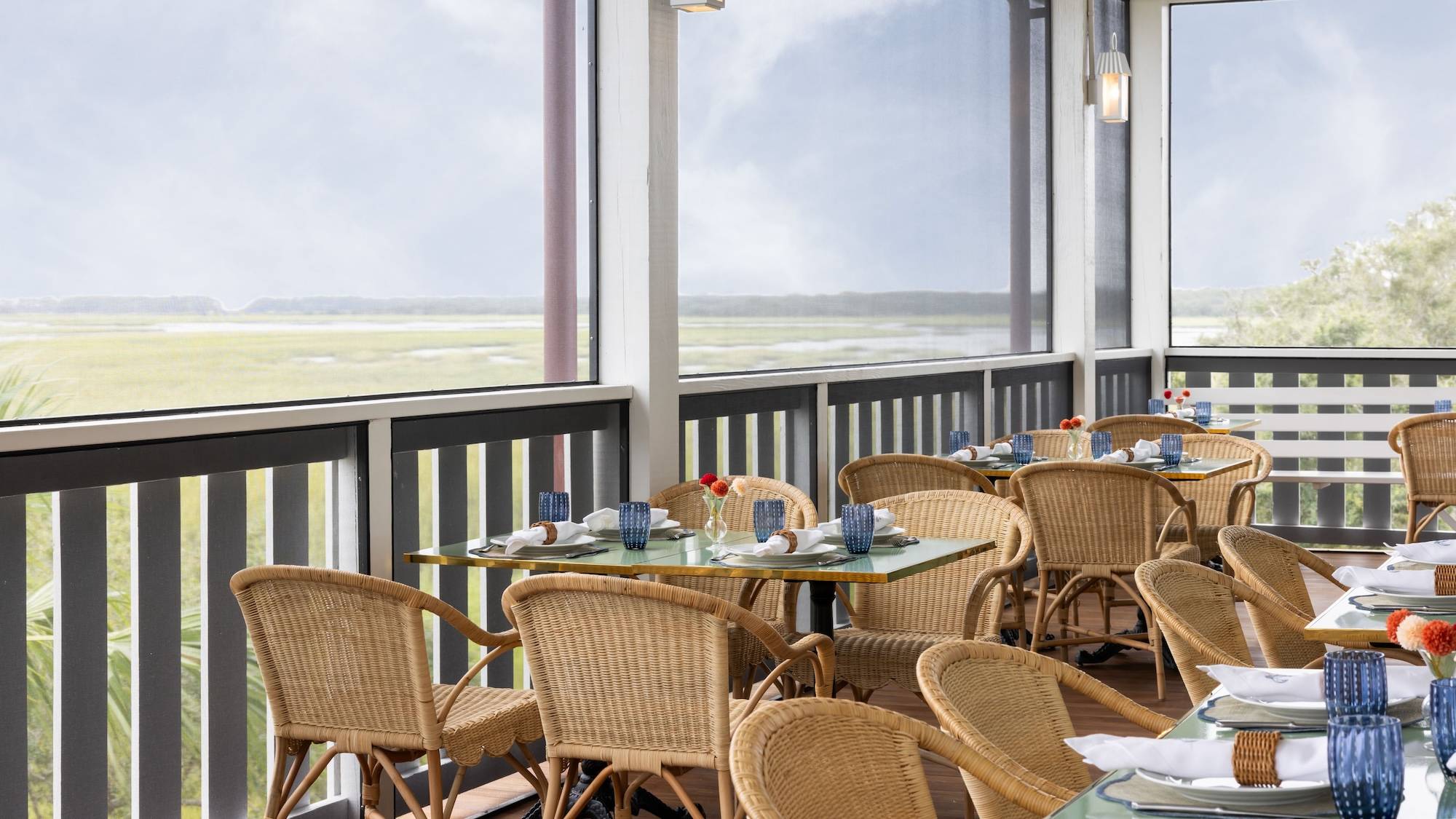 The screened dining porch overlooking the marsh at The Dunlin