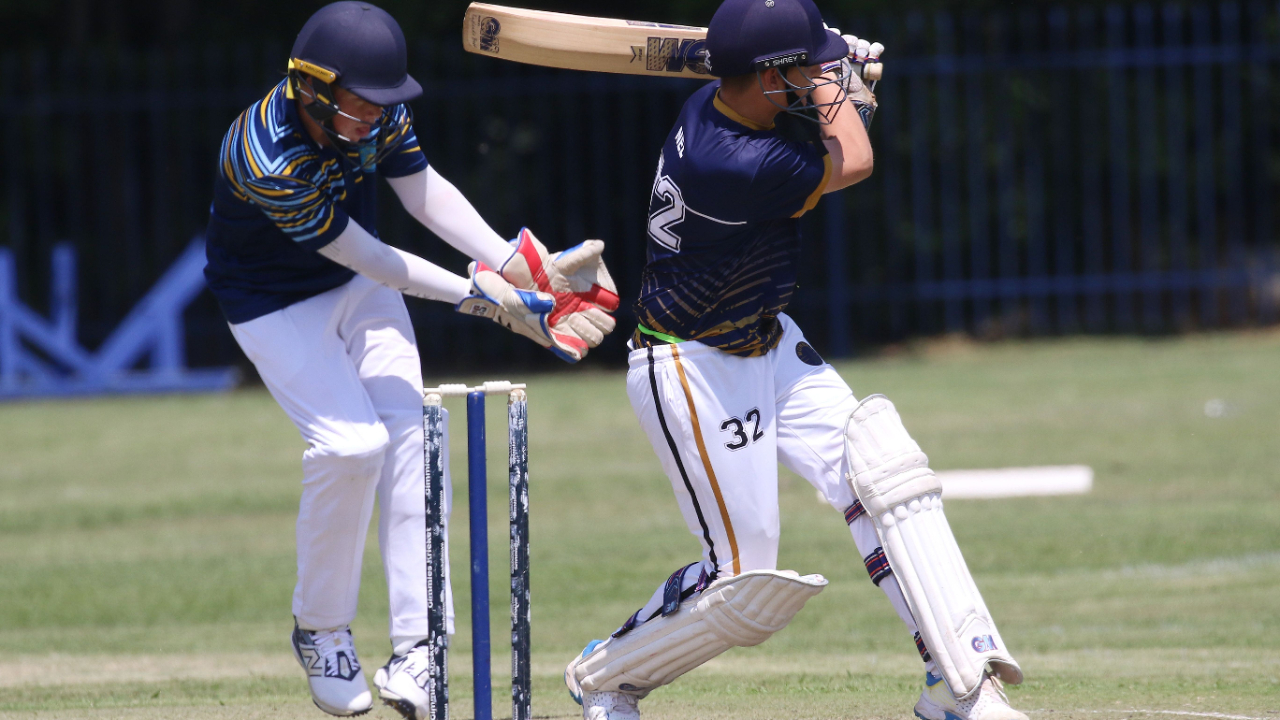 2 men playing cricket