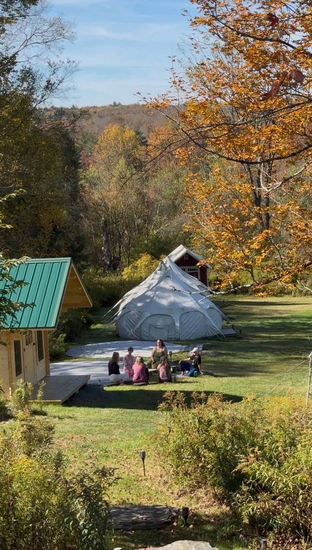 A small group sitting together outdoors in autumn
