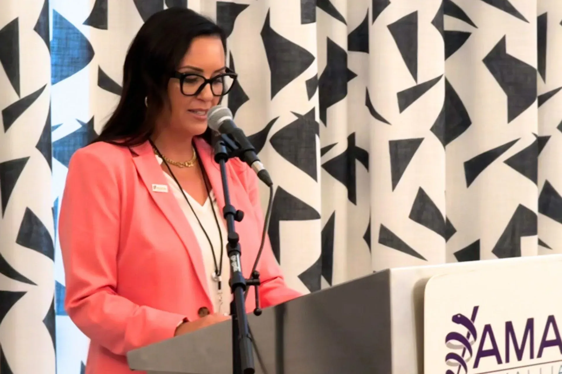 Dr. Lisa Muehlenbein speaking at an AMA Alliance event, delivering research-backed presentations on physician burnout and medical family wellness.