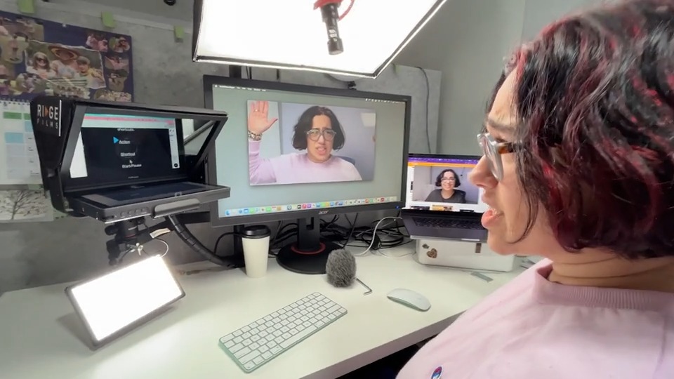 A Ridge client reviewing a recording of herself on screen, beside her teleprompter and LED light