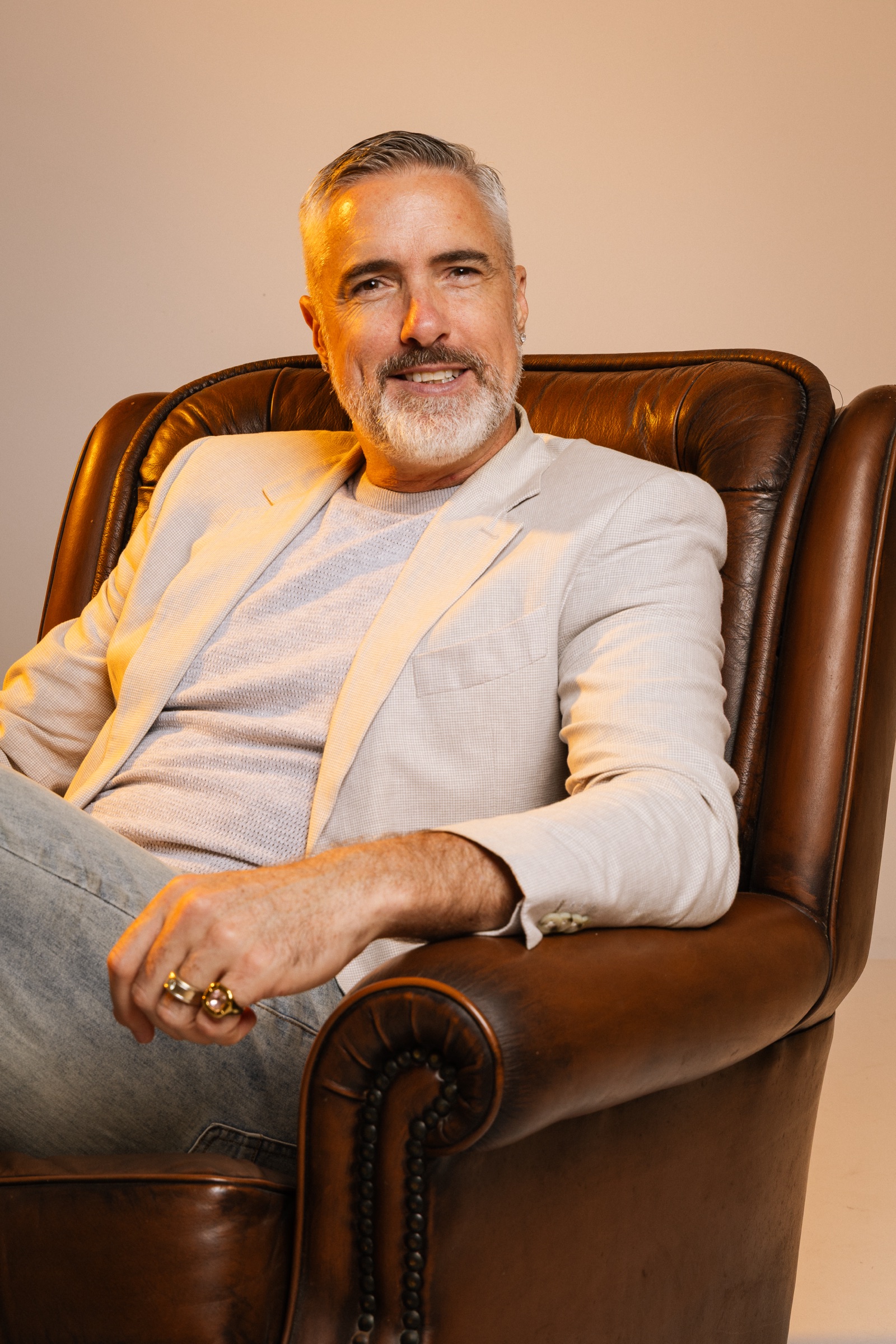 Chris Schwager, founder of Ridge Films, seated in a leather armchair