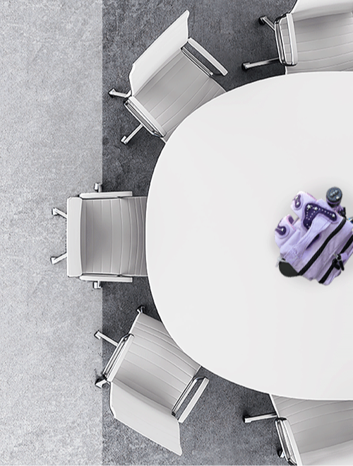 Color-coded Chroma Drop tactical packs in the center of a conference tables, ready for a facilitated teambuilding experience.