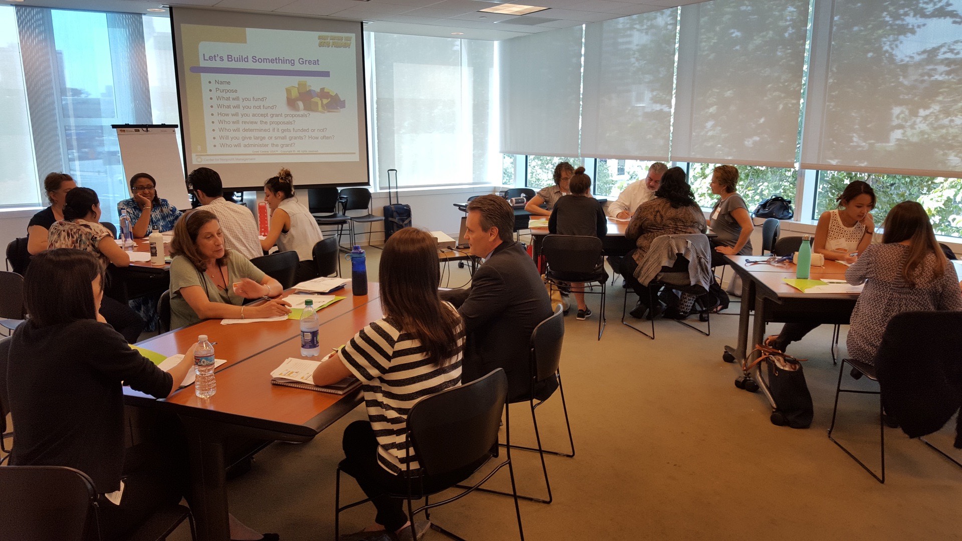 Participants working together during a live Grant Central USA grant writing workshop.