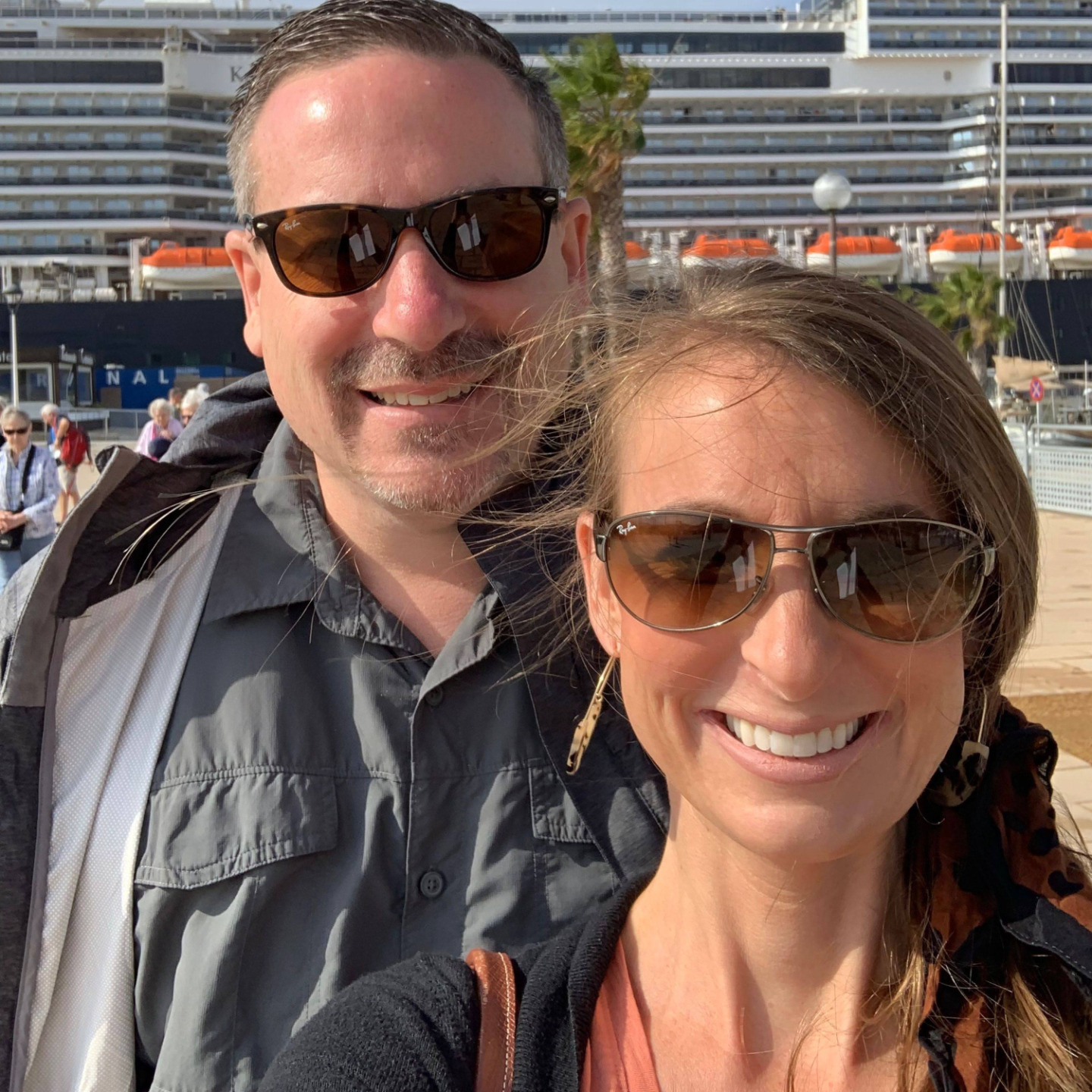 scott and melissa in front of a cruise ship in spain