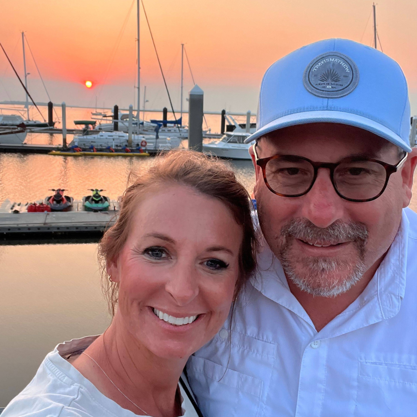 scott and melissa in front of an amelia island sunset