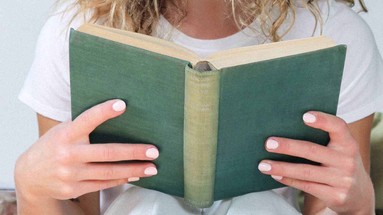 Person reading a book, symbolising storytelling, communication, and the power of narrative