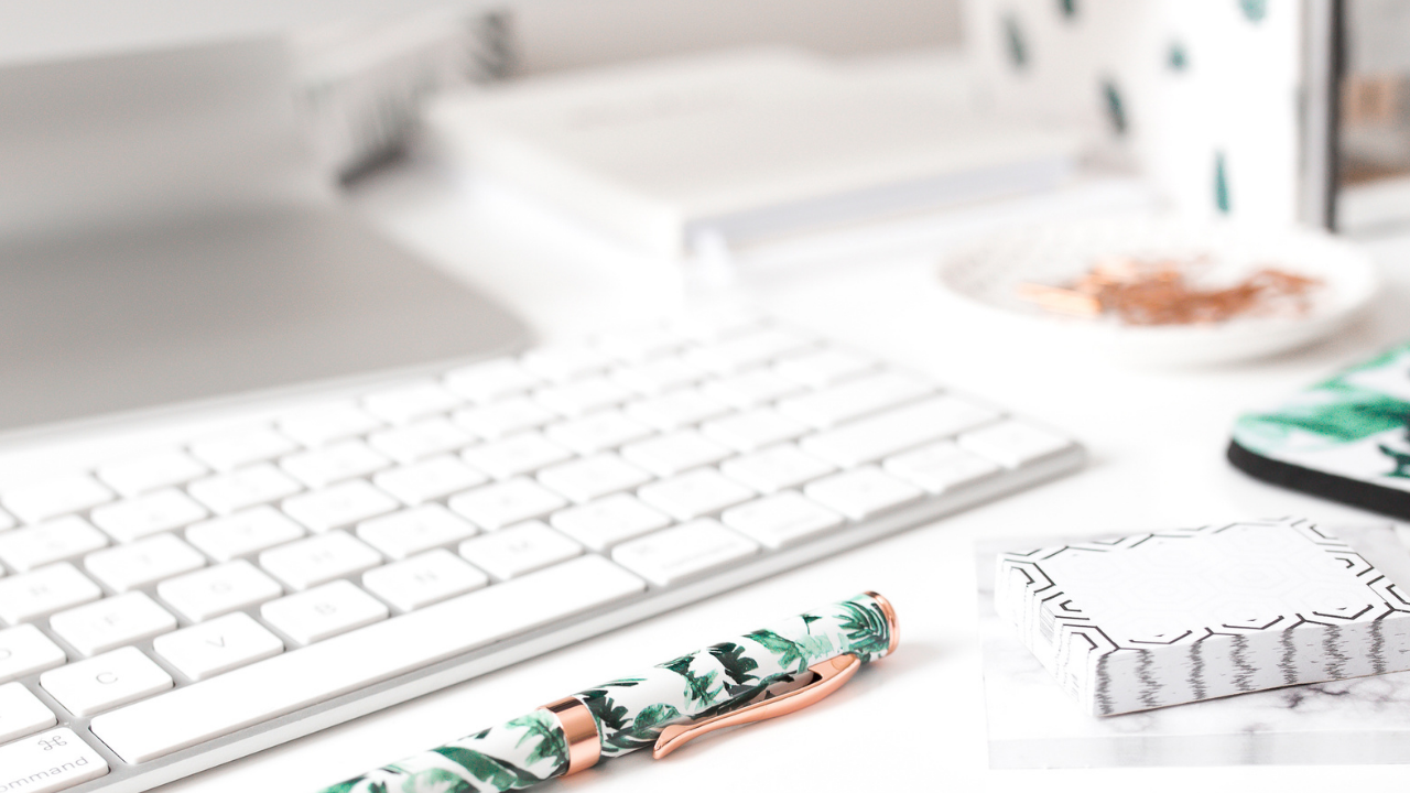 Workspace desk with keyboard, notebook and stationery representing women in business, entrepreneurship and business mindset growth