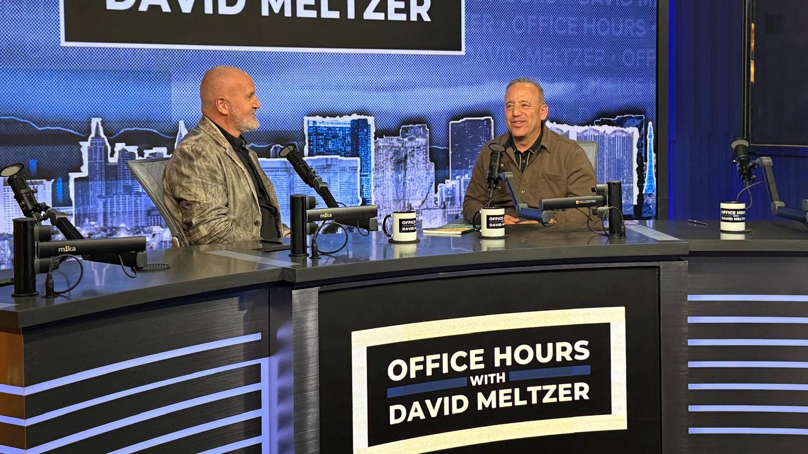 Two speakers recording a podcast episode in a studio labeled “Office Hours with David Meltzer,” sitting behind microphones and discussing personal development