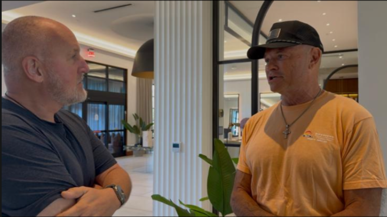 Two men having a serious conversation indoors during a discussion about parenting, communication, and the impact of seven important words taught to children